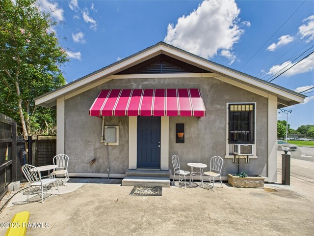 1206 Kaliste Saloom Rd, Lafayette, LA 70508 - view of front facade featuring a patio area, fence, and stucco siding