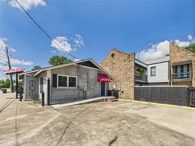 1206 Kaliste Saloom Rd, Lafayette, LA 70508 - view of front of house with uncovered parking, fence, and stucco siding