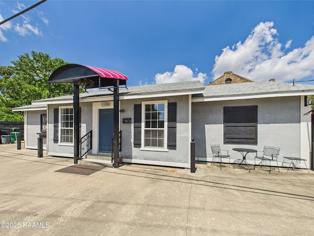1206 Kaliste Saloom Rd, Lafayette, LA 70508 - back of house with stucco siding and a patio area