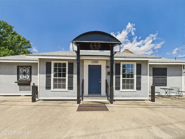 1206 Kaliste Saloom Rd, Lafayette, LA 70508 - view of front facade with stucco siding and a shingled roof