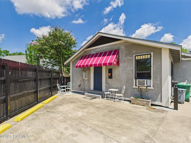 1206 Kaliste Saloom Rd, Lafayette, LA 70508 - back of property featuring fence, a patio, stucco siding, and cooling unit