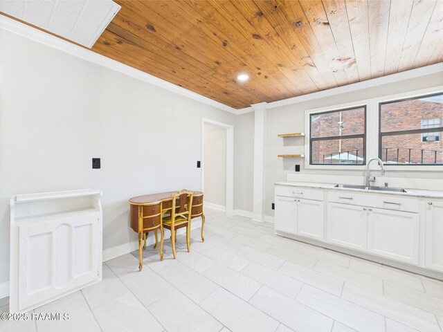 1206 Kaliste Saloom Rd, Lafayette, LA 70508 - kitchen with wooden ceiling, ornamental molding, a sink, light countertops, and white cabinetry