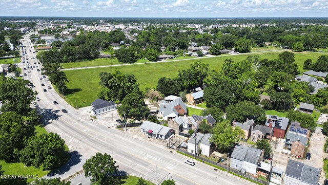 1206 Kaliste Saloom Rd, Lafayette, LA 70508 - aerial perspective of suburban area featuring a tree filled landscape and a main thoroughfare