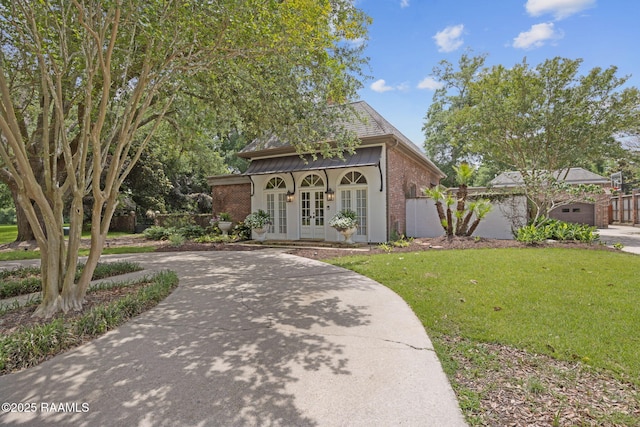 315 Kings Rd, Lafayette, LA 70503 - view of home's community with a lawn, driveway, and an outbuilding