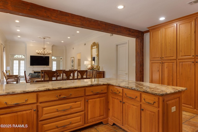315 Kings Rd, Lafayette, LA 70503 - kitchen with crown molding, recessed lighting, light stone countertops, open floor plan, and a chandelier