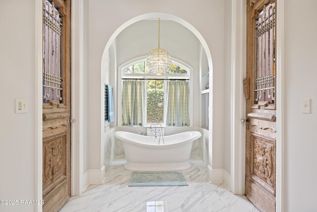 408 Princeton Woods Loop, Lafayette, LA 70508 - bathroom featuring marble finish flooring, a soaking tub, and a chandelier