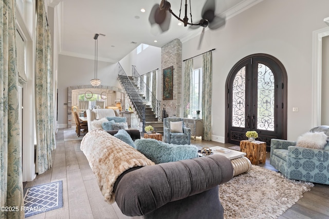 408 Princeton Woods Loop, Lafayette, LA 70508 - living room with arched walkways, stairway, crown molding, wood-type flooring, and a high ceiling
