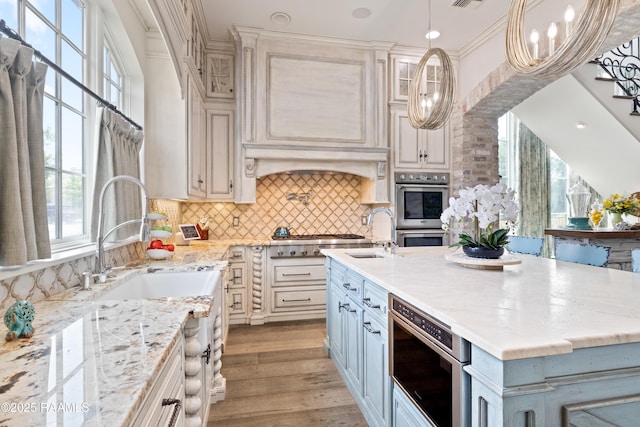 408 Princeton Woods Loop, Lafayette, LA 70508 - kitchen featuring stainless steel appliances, a kitchen island with sink, light stone counters, and tasteful backsplash