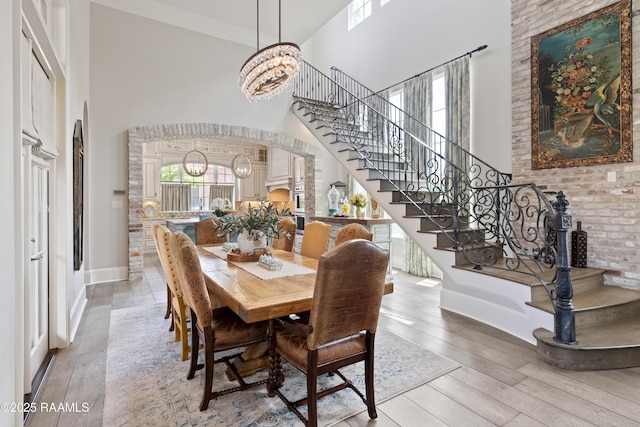 408 Princeton Woods Loop, Lafayette, LA 70508 - dining area with a high ceiling, stairs, light wood-style floors, a chandelier, and ornamental molding