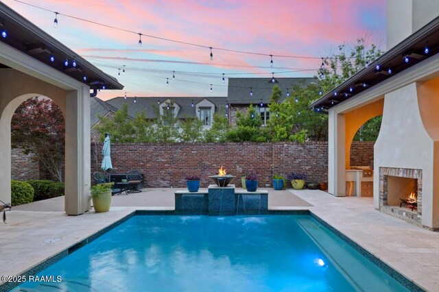 408 Princeton Woods Loop, Lafayette, LA 70508 - view of pool featuring a lit fireplace and a patio area