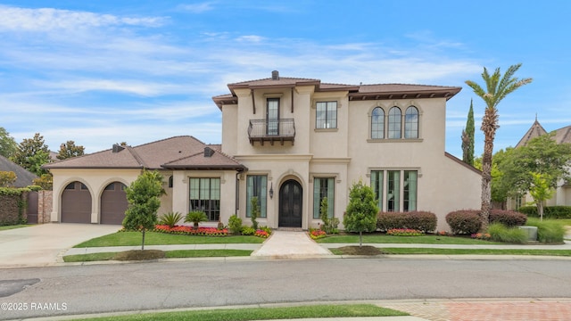 408 Princeton Woods Loop, Lafayette, LA 70508 - mediterranean / spanish-style home featuring driveway, a balcony, stucco siding, and an attached garage