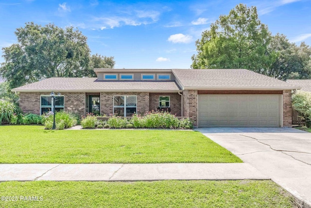 109 Bellevedere Ave, Lafayette, LA 70503 - view of front facade featuring brick siding, an attached garage, driveway, a front lawn, and roof with shingles