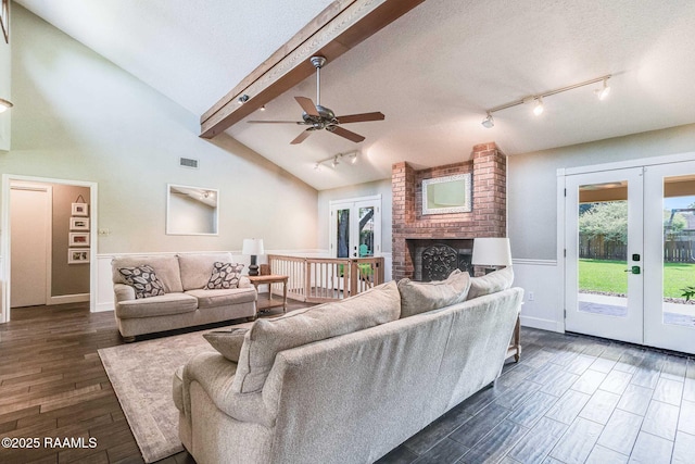 109 Bellevedere Ave, Lafayette, LA 70503 - living area with french doors, track lighting, dark wood-style flooring, a ceiling fan, and a wainscoted wall