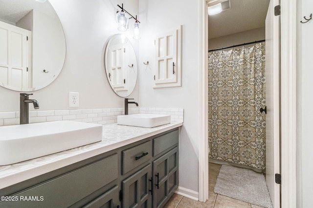 109 Bellevedere Ave, Lafayette, LA 70503 - full bath with double vanity, tile patterned flooring, and decorative backsplash