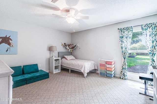 109 Bellevedere Ave, Lafayette, LA 70503 - carpeted bedroom featuring access to exterior, ceiling fan, and a textured ceiling