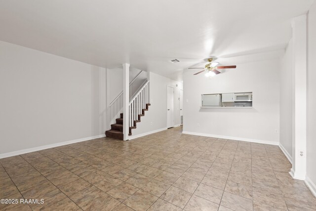 116 Southfield Pkwy, Lafayette, LA 70506 - unfurnished living room with a ceiling fan, stairway, and baseboards