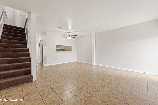 116 Southfield Pkwy, Lafayette, LA 70506 - unfurnished living room featuring a ceiling fan, stairs, light tile patterned floors, and baseboards