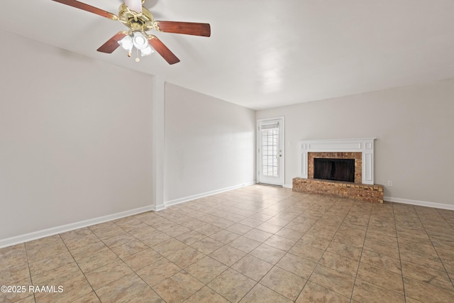 116 Southfield Pkwy, Lafayette, LA 70506 - unfurnished living room with a brick fireplace, a ceiling fan, tile patterned floors, and baseboards
