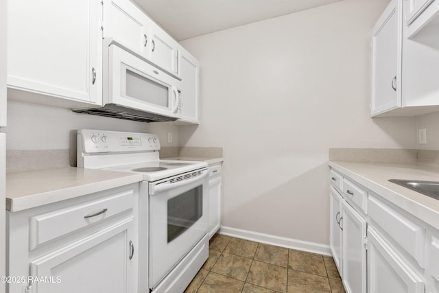 116 Southfield Pkwy, Lafayette, LA 70506 - kitchen with white appliances, white cabinets, baseboards, and light countertops