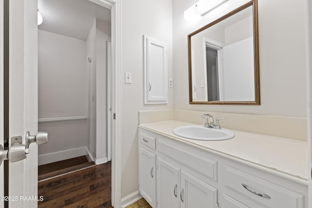 116 Southfield Pkwy, Lafayette, LA 70506 - bathroom with wood finished floors, vanity, and baseboards