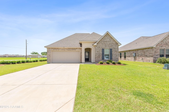 101 Micah Edward, Maurice, LA 70555 - view of front of house featuring a garage, driveway, a front yard, and brick siding