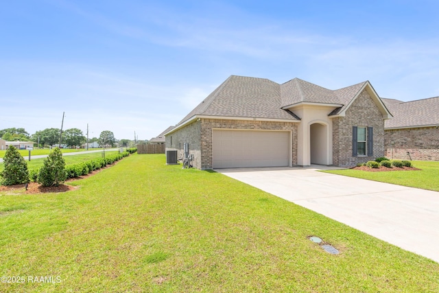 101 Micah Edward, Maurice, LA 70555 - view of front of home featuring a garage, central AC unit, driveway, a front lawn, and a shingled roof