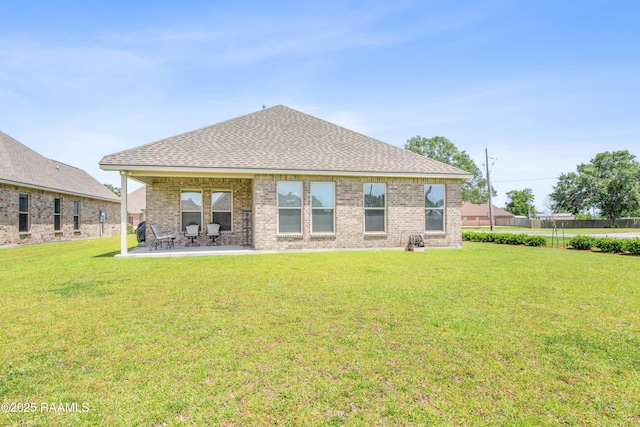 101 Micah Edward, Maurice, LA 70555 - rear view of property with roof with shingles, a lawn, brick siding, and a patio
