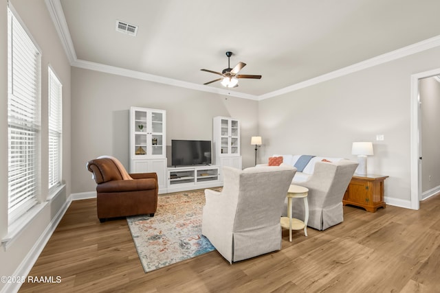 101 Micah Edward, Maurice, LA 70555 - living room featuring ceiling fan, crown molding, light wood-type flooring, and plenty of natural light