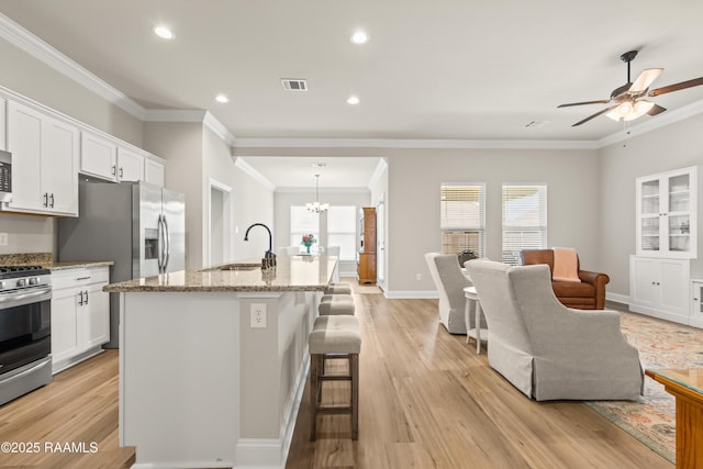 101 Micah Edward, Maurice, LA 70555 - kitchen with appliances with stainless steel finishes, a sink, light wood-style floors, a ceiling fan, and healthy amount of natural light
