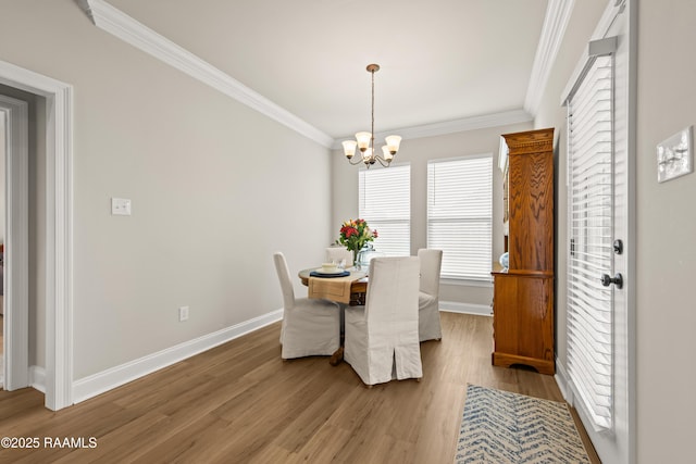 101 Micah Edward, Maurice, LA 70555 - dining space featuring plenty of natural light, baseboards, ornamental molding, wood finished floors, and a chandelier