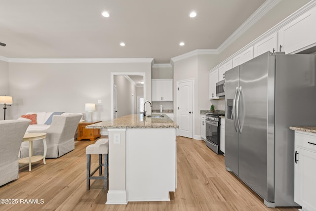 101 Micah Edward, Maurice, LA 70555 - kitchen featuring stainless steel appliances, a sink, white cabinets, crown molding, and open floor plan