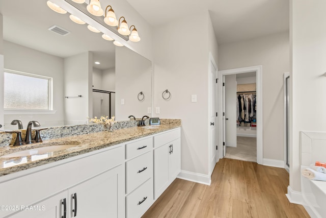 101 Micah Edward, Maurice, LA 70555 - full bath featuring a shower stall, double vanity, wood finished floors, a spacious closet, and baseboards