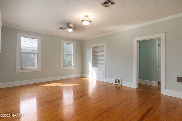 308 Boas Ave, New Iberia, LA 70563 - unfurnished room featuring ornamental molding, built in shelves, ceiling fan, wood finished floors, and baseboards