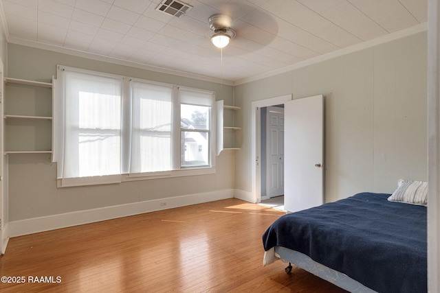 308 Boas Ave, New Iberia, LA 70563 - bedroom with ornamental molding, light wood-style flooring, baseboards, and ceiling fan