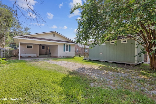 308 Boas Ave, New Iberia, LA 70563 - back of house featuring ceiling fan, a patio area, driveway, and a carport