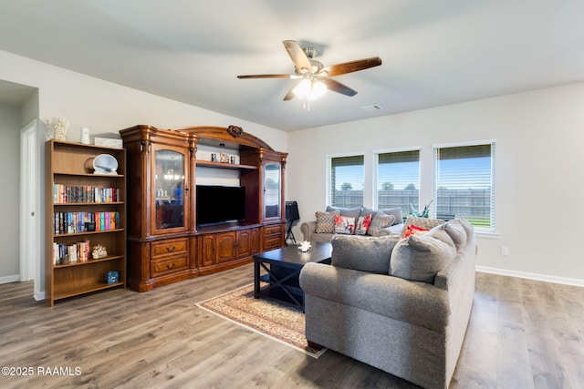 7014 Acacia Lake Dr, Maurice, LA 70555 - living room featuring a ceiling fan, light wood finished floors, and baseboards