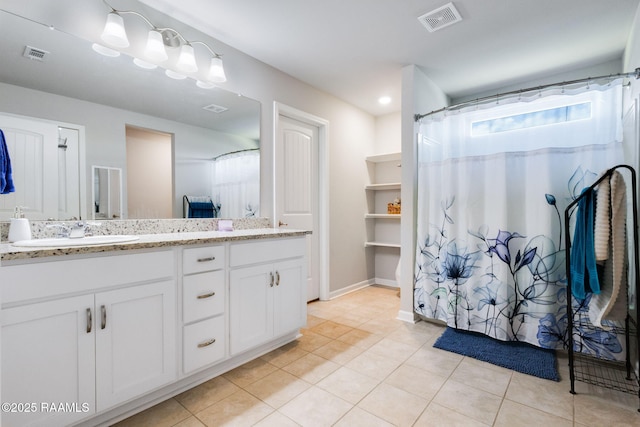 7014 Acacia Lake Dr, Maurice, LA 70555 - bathroom with tile patterned flooring, vanity, and baseboards