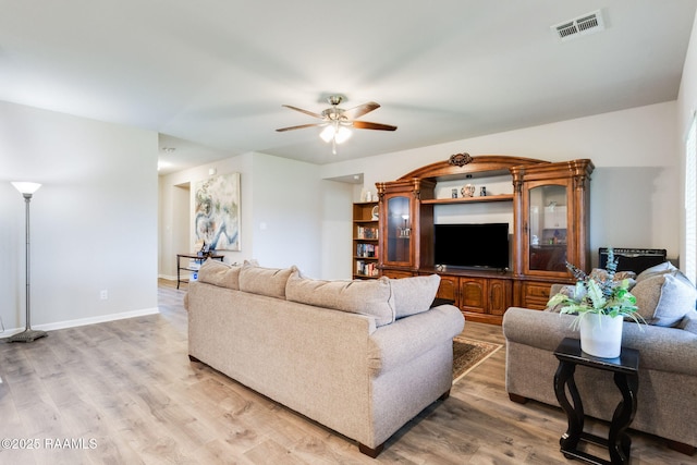 7014 Acacia Lake Dr, Maurice, LA 70555 - living area with ceiling fan, light wood-type flooring, and baseboards