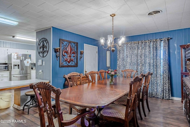 1005 Tensas Dr, Opelousas, LA 70570 - dining space featuring dark wood-type flooring and a chandelier