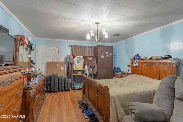1005 Tensas Dr, Opelousas, LA 70570 - bedroom with crown molding, a chandelier, and light wood finished floors