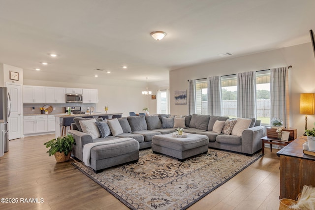 110 Casa Bella Ct, Breaux Bridge, LA 70517 - living area with a chandelier, light wood-type flooring, and recessed lighting