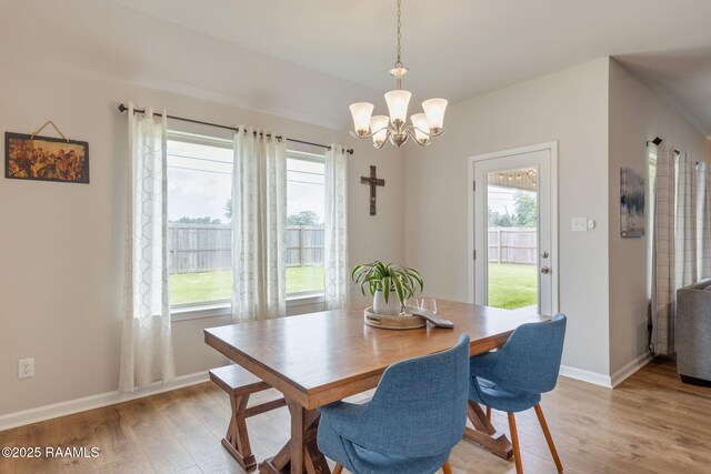 110 Casa Bella Ct, Breaux Bridge, LA 70517 - dining space featuring a chandelier, light wood-style flooring, and plenty of natural light