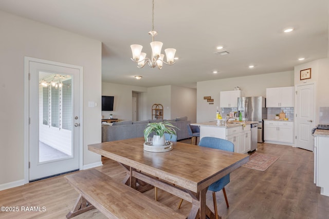 110 Casa Bella Ct, Breaux Bridge, LA 70517 - dining space featuring a chandelier, light wood-style floors, and recessed lighting