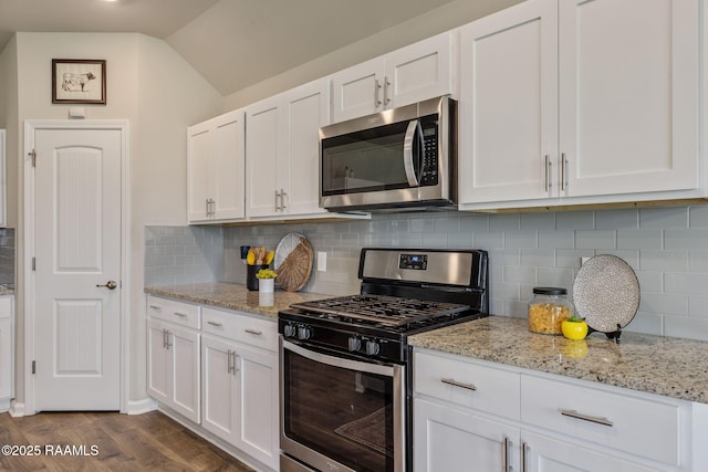 110 Casa Bella Ct, Breaux Bridge, LA 70517 - kitchen with stainless steel appliances, white cabinetry, and vaulted ceiling