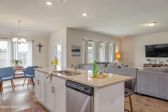 110 Casa Bella Ct, Breaux Bridge, LA 70517 - kitchen with dishwasher, a chandelier, open floor plan, wood finished floors, and a center island with sink