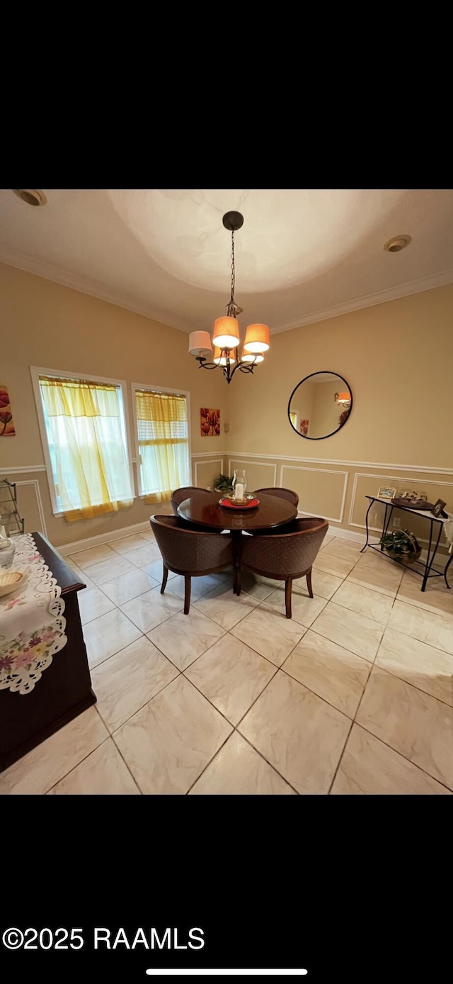 4306 Holly Dr, Slidell, LA 70461 - dining room featuring crown molding, a chandelier, a decorative wall, and a wainscoted wall