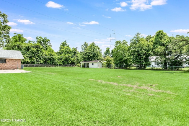 506 Rice Ln, Opelousas, LA 70570 - view of yard with an outdoor structure and view of wooded area
