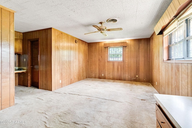 506 Rice Ln, Opelousas, LA 70570 - carpeted spare room featuring wooden walls and a ceiling fan