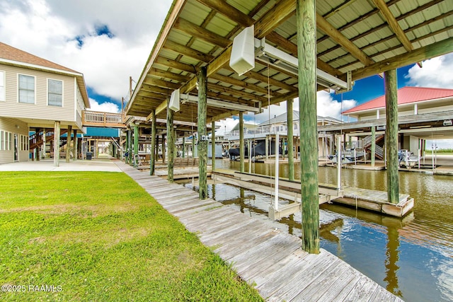 102-104 Trout Ct, Dulac, LA 70353 - dock area featuring boat lift, a water view, and a yard