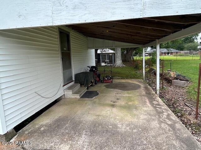 143 Monette St, Ville Platte, LA 70586 - view of patio / terrace featuring a carport and entry steps